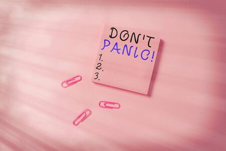 Conceptual hand writing showing Don T Panic. Concept meaning suddenly feel so worried or frightened that you can not behave Colored sticky note clips gathered trendy cool pastel backgroundの写真素材