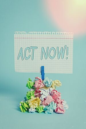 Writing note showing Act Now. Business concept for fulfil the function or serve the purpose of Take action Do something Reminder pile colored crumpled paper clothespin wooden spaceの写真素材