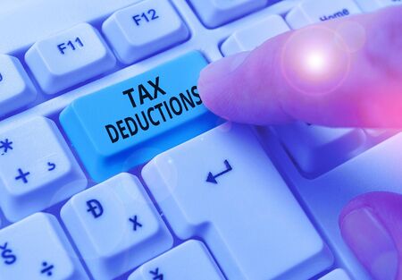Writing note showing Tax Deductions. Business concept for amount or cost that can be subtracted from someone s is incomeの写真素材