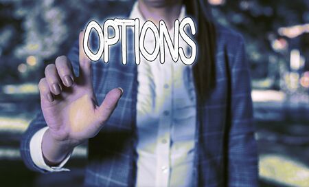 Word writing text Options. Business photo showcasing the opportunity or ability to choose something or to choose Business woman in the nature pointing with the finger into empty spaceの写真素材