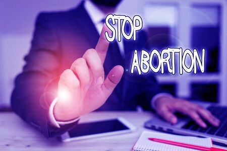 Handwriting text Stop Abortion. Conceptual photo to stop medical procedure that used to end a pregnancy Male human wear formal clothes present presentation use hi tech smartphoneの写真素材