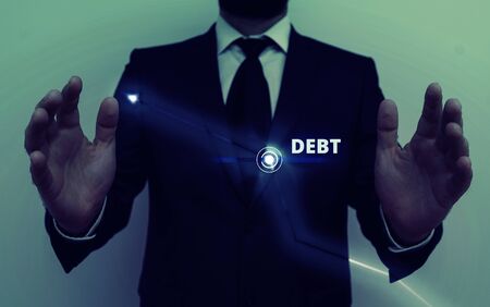 Conceptual hand writing showing Debt. Concept meaning a sum of money that a demonstrating or organization owes to someone or a bankの写真素材