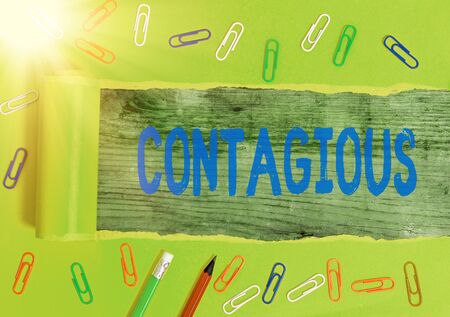 Writing note showing Contagious. Business concept for transmissible by direct or indirect contact with someone infectedの写真素材