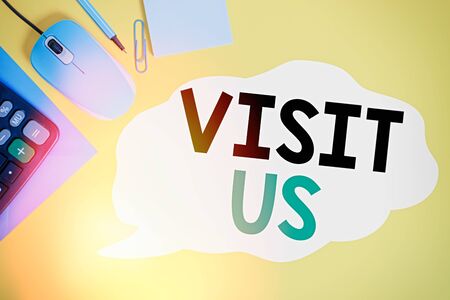Writing note showing Visit Us. Business concept for Invitation Watch A web page Link to Homepage Blog Internet Closed envelope clip mouse calculator pencil note colored backgroundの写真素材