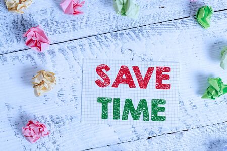 Text sign showing Save Time. Business photo text to do something more efficiently such that less time is required Crumpled colored rectangle square shaped paper reminder white wood deskの写真素材