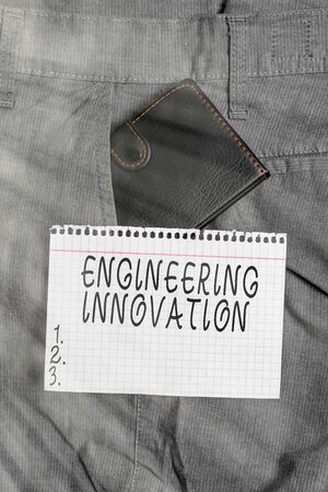 Conceptual hand writing showing Engineering Innovation. Concept meaning Process expressed in Logic and Mathematical Form Small wallet inside trouser front pocket near notation paperの写真素材