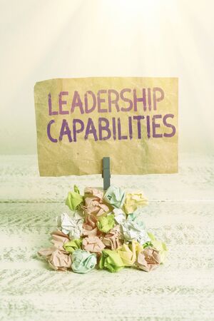 Text sign showing Leadership Capabilities. Business photo text Set of Performance Expectations a Leader Competency Reminder pile colored crumpled paper clothespin reminder white wooden spaceの写真素材