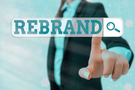Writing note showing Rebrand. Business concept for Change corporate image of company organization Marketing strategyの写真素材
