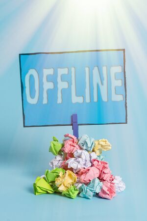 Writing note showing Offline. Business concept for Not having directly connected to a computer or external network Reminder pile colored crumpled paper clothespin wooden spaceの写真素材