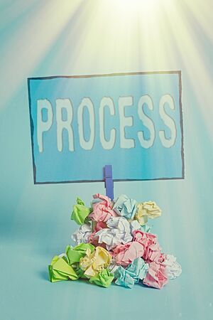 Writing note showing Process. Business concept for Standard procedures how to handle a particular job rules system Reminder pile colored crumpled paper clothespin wooden spaceの写真素材