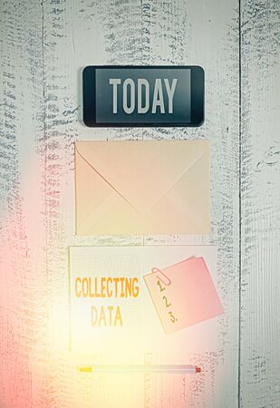 Word writing text Collecting Data. Business photo showcasing Gathering and measuring information on variables of interest Envelop smartphone notepad note clip marker old wooden vintage backgroundの写真素材