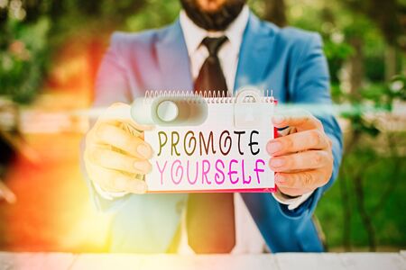 Writing note showing Promote Yourself. Business concept for market and introduce to others Improvement Encourageの写真素材