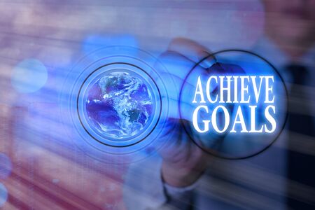 Writing note showing Achieve Goals. Business concept for Results oriented Reach Target Effective Planning Succeedの写真素材