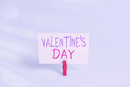 Conceptual hand writing showing Valentine S Day. Concept meaning time when showing show feelings of love and affection Colored clothespin rectangle shaped paper blue backgroundの写真素材