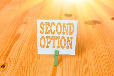 Handwriting text Second Option. Conceptual photo Next Fiddle Not a priority Next Alternative Opportunity Empty reminder wooden floor background green clothespin groove slot officeの写真素材