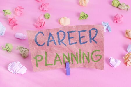 Conceptual hand writing showing Career Planning. Concept meaning Strategically plan your career goals and work success Colored crumpled papers empty reminder pink floor clothespinの写真素材