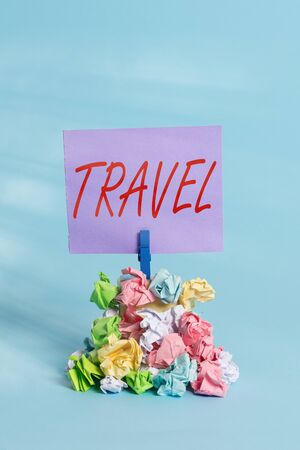 Handwriting text Travel. Conceptual photo the movement of showing between distant geographical locations Reminder pile colored crumpled paper clothespin reminder blue backgroundの写真素材