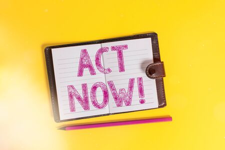 Text sign showing Act Now. Business photo text fulfil the function or serve the purpose of Take action Do something Dark leather private locked diary striped sheets marker colored backgroundの写真素材