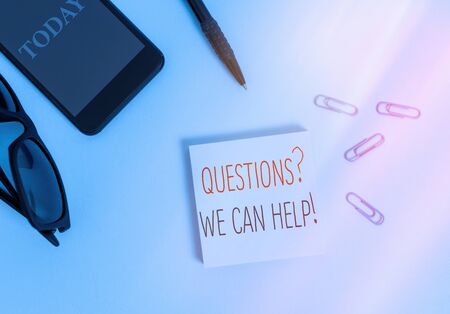 Text sign showing Questions We Can Help. Business photo text offering help to those who wants to know Eyeglasses colored sticky note smartphone cell clips pen pastel backgroundの写真素材
