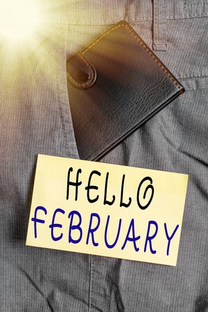 Writing note showing Hello February. Business concept for greeting used when welcoming the second month of the year Small wallet inside trouser front pocket near notation paperの写真素材