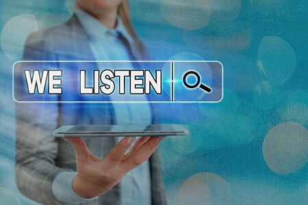 Text sign showing We Listen. Business photo text an organization willing to pay attention by offering their earsの写真素材