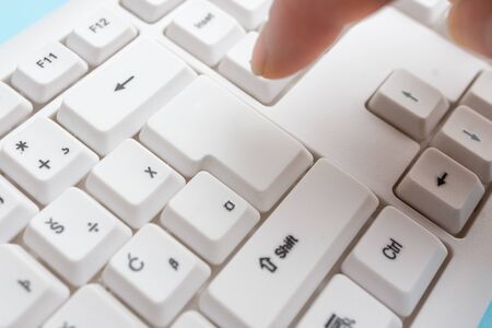 Pc keyboard key with pointing finger above background copy space