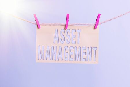 Word writing text Asset Management. Business photo showcasing precise handling of resources for future economic benefits Clothesline clothespin rectangle shaped paper reminder white wood deskの写真素材