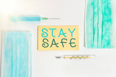 Conceptual hand writing showing Stay Safe. Concept meaning secure from threat of danger, harm or place to keep articles Set of medical equipment with notepad for health assessmentの写真素材