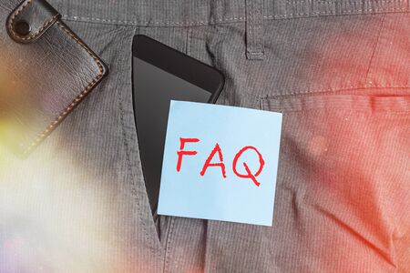 Conceptual hand writing showing Faq. Concept meaning list of frequently asked questions and answers on a particular topic Smartphone device inside trousers front pocket with walletの写真素材