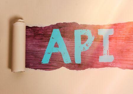 Handwriting text writing Api. Conceptual photo set of routines, protocols, and tools for building software applications Rolled ripped torn cardboard placed above a wooden classic table backdropの写真素材