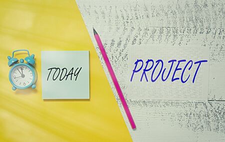 Writing note showing Project. Business concept for collaborative enterprise carefully plan design to achieve success Notepad marker colored paper sheets retro alarm clock wooden backgroundの写真素材