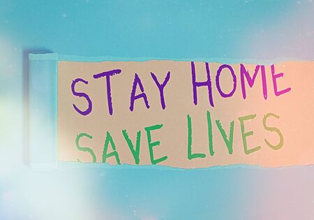 Handwriting text writing Stay Home Save Lives. Conceptual photo lessen the number of infected patients by not leaving the house Rolled ripped torn cardboard placed above a wooden classic table backdropの写真素材