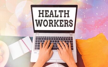 Word writing text Health Workers. Business photo showcasing showing whose job to protect the health of their communities Modern gadgets with white display screen under colorful bokeh backgroundの写真素材