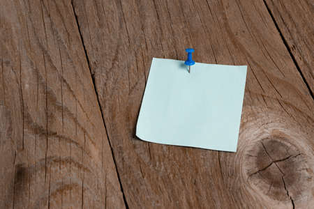 Pinned Different Color Sticker Notes Arranged On Wood Textured Tableの写真素材