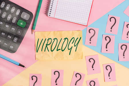 Writing note showing Virology. Business concept for branch of science dealing with the variety of viral agents and disease Mathematics stuff and writing equipment above pastel colours backgroundの写真素材