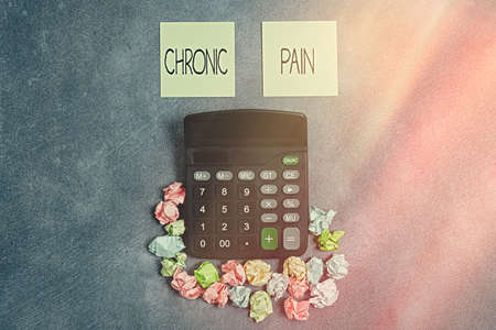 Writing note showing Chronic Pain. Business concept for discomfort that persists or progresses over a long period Paper accessories with smartphone arranged on different backgroundの写真素材