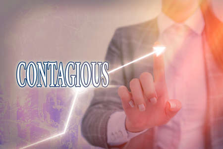 Writing note showing Contagious. Business concept for transmissible by direct or indirect contact with infected an individual Arrow symbol going upward showing significant achievementの写真素材