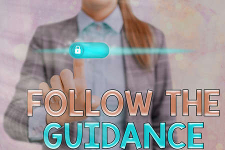 Word writing text Follow The Guidance. Business photo showcasing controlling a course of projectile by builtin mechanism Graphics padlock for web data information security application systemの写真素材