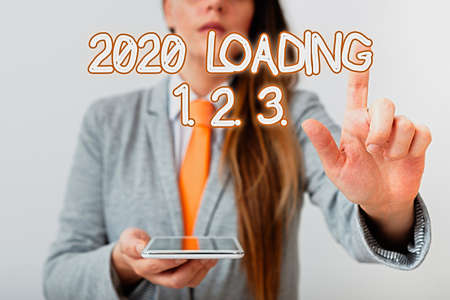 Handwriting text 2020 Loading 1. 2. 3.. Conceptual photo welcoming the beginning of the new year Countdown Model with pointing hand finger symbolizing navigation progress growthの写真素材