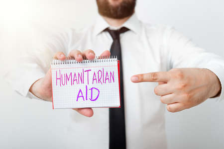 Writing note showing Humanitarian Aid. Business concept for immediate assistance provided after natural and manmade disaster Model displaying different empty color notepad mock-up for writing ideaの写真素材