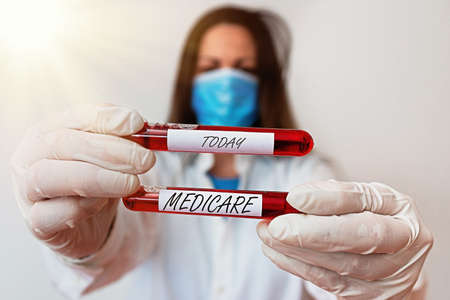 Word writing text Medicare. Business photo showcasing a policy of the federal government providing health care coverage Laboratory blood test sample shown for medical diagnostic analysis resultの写真素材