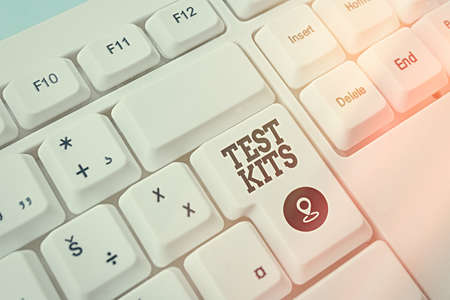 Text sign showing Test Kits. Business photo showcasing tools used to detect the presence of something in the body Pc keyboard key with empty note paper above background copy spaceの写真素材