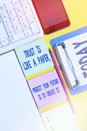 Writing note showing The Best Way To Predict Your Future Is To Create It.. Business concept for Hard work Motivation Empty papers with copy space on yellow background tableの写真素材