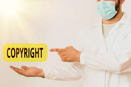 Word writing text Copyright. Business photo showcasing exclusive legal right to reproduce, publish, sell, or distribute Displaying Empty Sticker Paper Accessories Smartphone With Medical Gloves Onの写真素材
