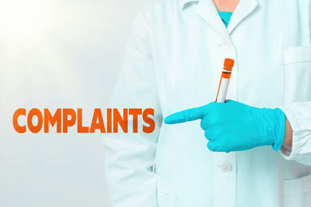 Handwriting text writing Complaints. Conceptual photo something that is the cause or subject of protest or outcry Laboratory blood test sample shown for medical diagnostic analysis resultの写真素材