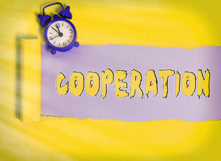 Word writing text Cooperation. Business photo showcasing actions of someone who is being helpful by doing what is wanted Rolled ripped torn cardboard placed above a wooden classic table backdropの写真素材