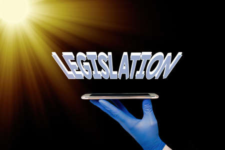 Writing note showing Legislation. Business concept for the exercise of the power and function of making rules Displaying Sticker Paper Accessories With Medical Gloves Onの写真素材