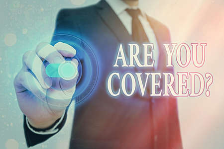 Writing note showing Are You Covered Question. Business concept for asking if they had insurance in work or life Graphics padlock for web data information security application systemの写真素材