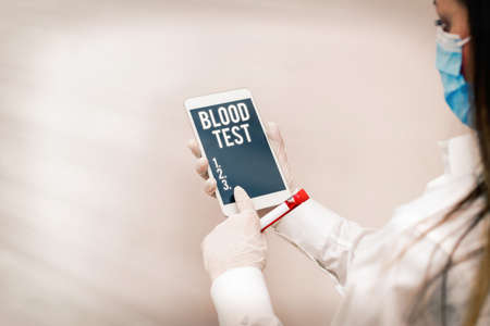 Text sign showing Blood Test. Business photo showcasing Extracted blood sample from an organism to perfom a laboratory analysis Extracted blood sample vial with lastest technology ready for examinationの写真素材