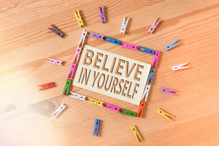 Word writing text Believe In Yourself. Business photo showcasing common piece of advice that you can do everything Colored clothespin papers empty reminder wooden floor background officeの写真素材